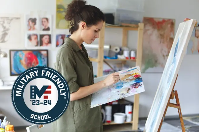 Military student painting at a canvas