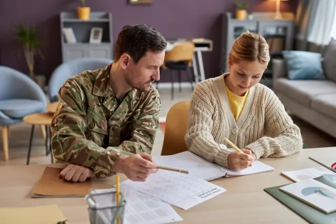 Military student and advisor filling out paperwork at a table