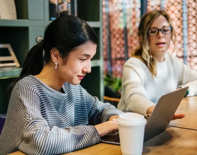 student and advisor working at a computer