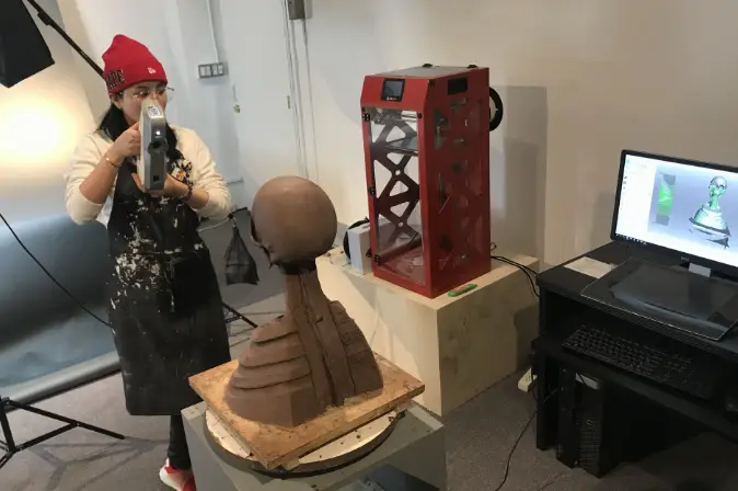 Girl using 3D printer in Sculpture studio