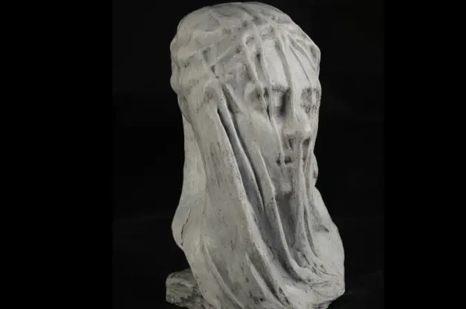 Sculpture piece of a woman's head shrouded by a veil