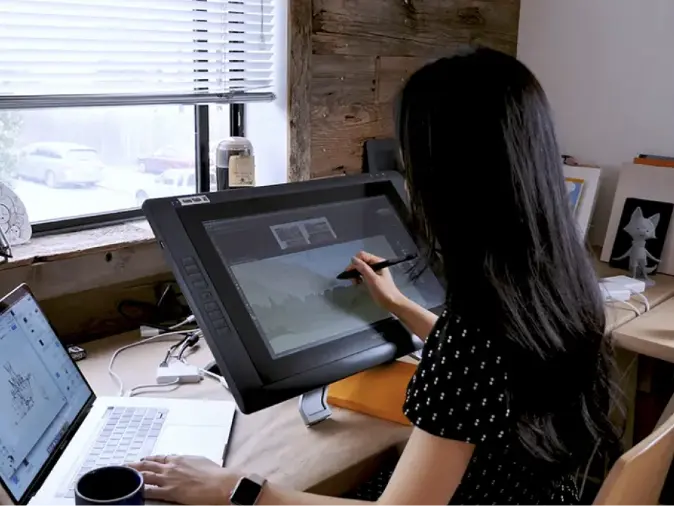 Girl working at a computer on a project